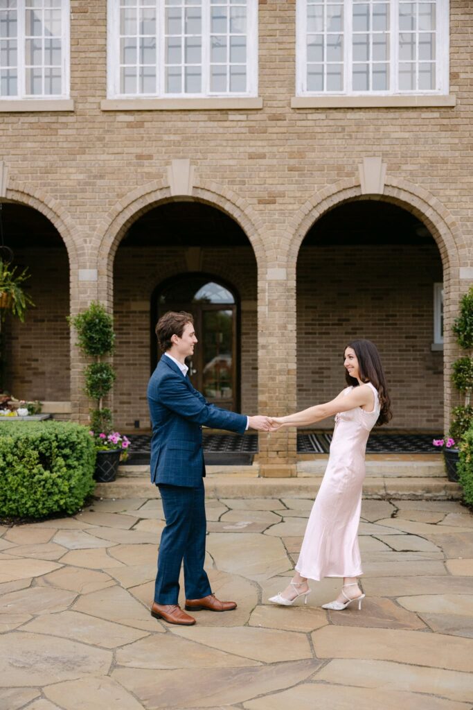 Francesca and Ben dancing in front of the Felt Mansion