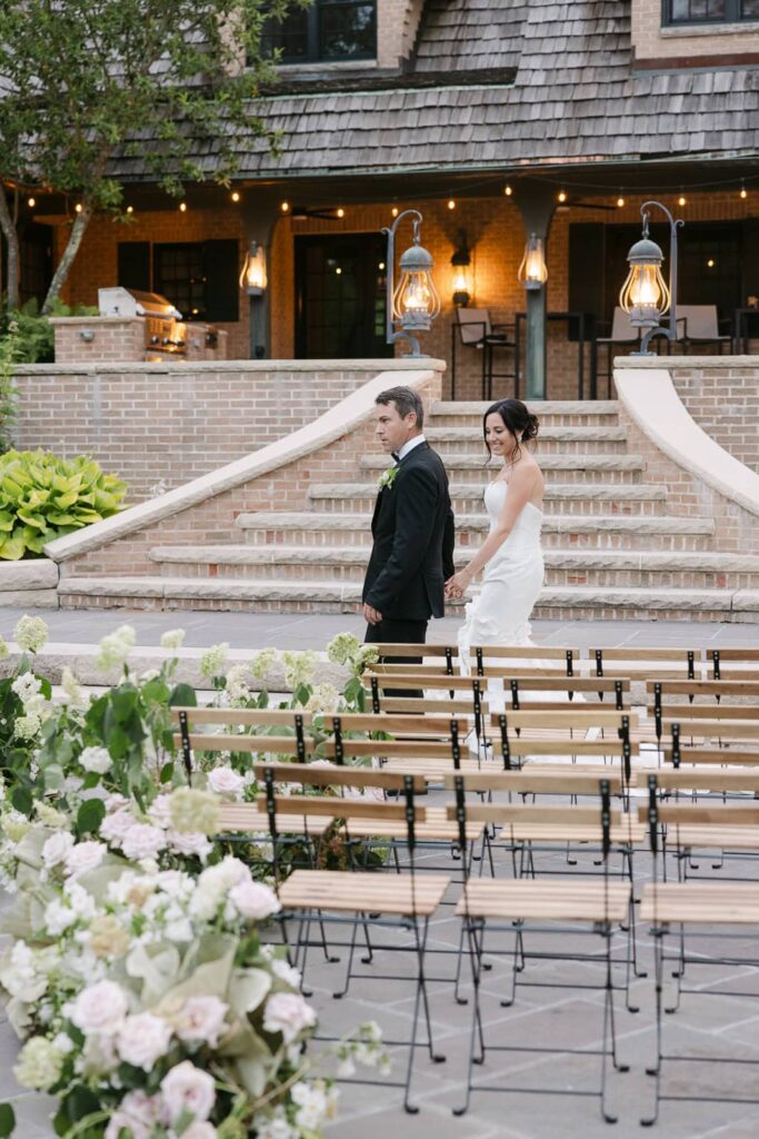 bride and groom walking in Front of basil Place 