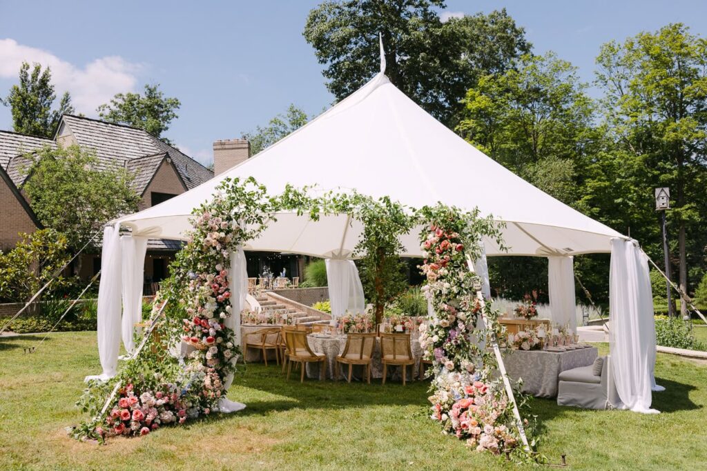Tent wedding recption with floral entrance