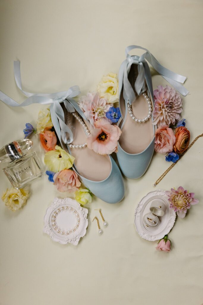 Brides Wedding details, blue shoes, pearl bracelet, earrings and perfume